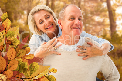Composite image of happy mature man giving piggy back to partner