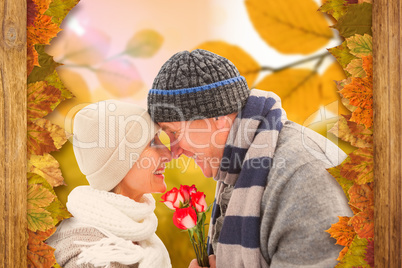 Composite image of happy mature couple in winter clothes with ro