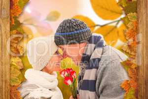 Composite image of happy mature couple in winter clothes with ro