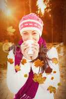 Composite image of winter brunette with coffee