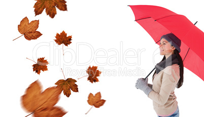 Composite image of smiling brunette holding red umbrella