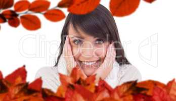 Composite image of brunette in winter clothes smiling at camera