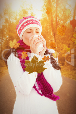 Composite image of attractive brunette holding coffee cup