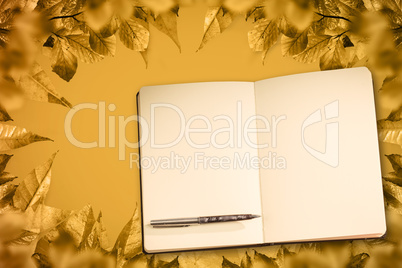 Composite image of notebook and pen