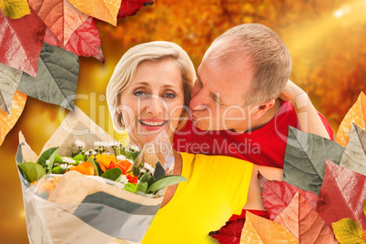 Composite image of mature man kissing his partner holding flower