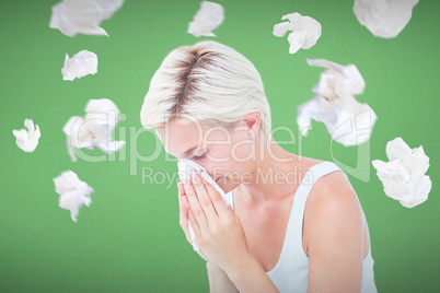 Composite image of sick woman blowing her nose