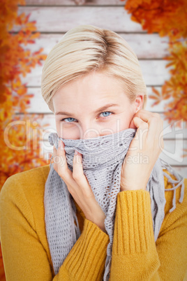 Composite image of smiling woman wearing a scarf