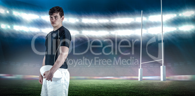 Composite image of rugby player holding a rugby ball