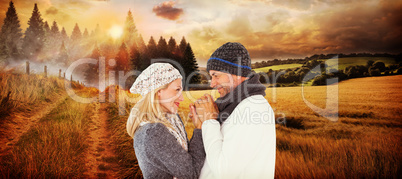 Composite image of cute smiling couple holding hands