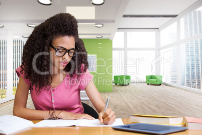 Composite image of student sitting in library writing