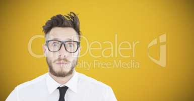 Composite image of geeky young businessman looking at camera