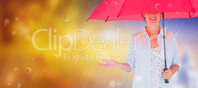 Composite image of woman holding an umbrella