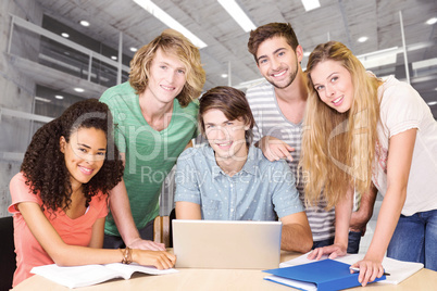 Composite image of college students using laptop in library