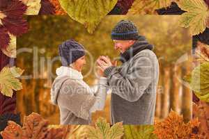 Composite image of happy mature couple in winter clothes embraci