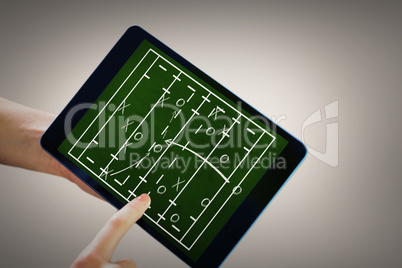 Composite image of finger pointing to tablet