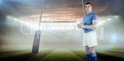 Composite image of rugby player holding rugby ball