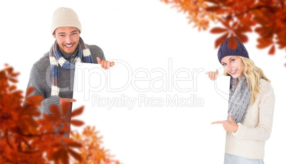 Composite image of attractive couple in winter fashion showing p