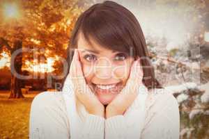 Composite image of brunette in winter clothes smiling at camera
