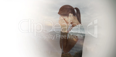 Composite image of side view of upset woman covering face