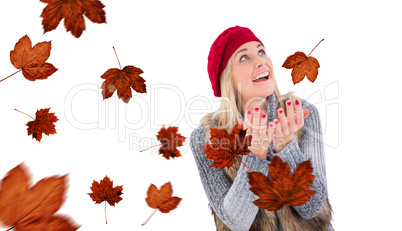 Composite image of blonde in winter clothes with hands out