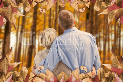 Composite image of mature couple hugging and looking Composite image of mature couple hugging and looking