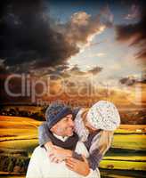 Composite image of happy cute couple romancing while embracing e