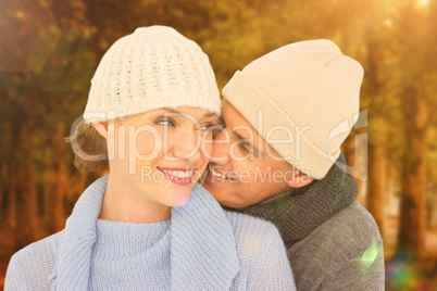 Composite image of casual couple in warm clothing