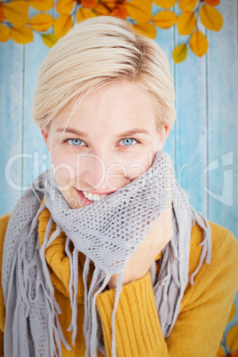 Composite image of cute woman wearing her scarf