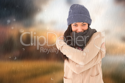 Composite image of attractive brunette looking at camera wearing