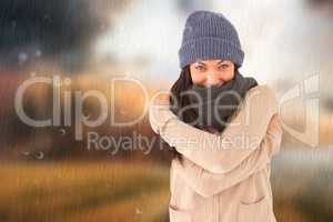 Composite image of attractive brunette looking at camera wearing