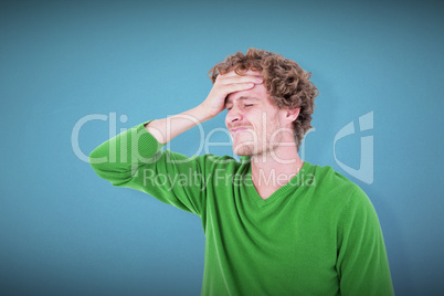 Composite image of anxious casual man standing with hand on fore