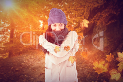 Composite image of attractive brunette looking at camera wearing