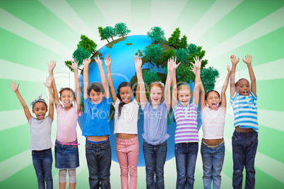 Composite image of cute pupils smiling at camera in classroom