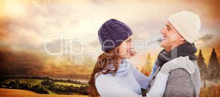 Composite image of happy couple in warm clothing