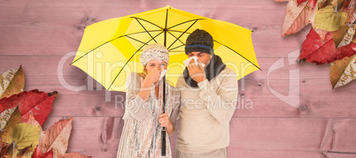 Composite image of couple sneezing in tissue while standing unde