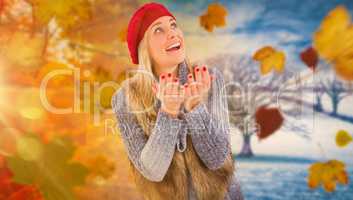Composite image of blonde in winter clothes with hands out