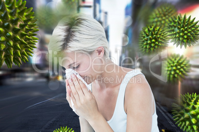 Composite image of sick woman blowing her nose