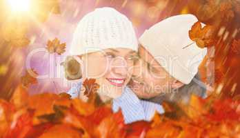 Composite image of casual couple in warm clothing