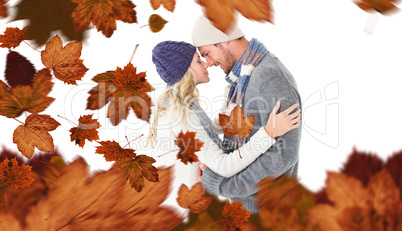 Composite image of attractive couple in winter fashion hugging