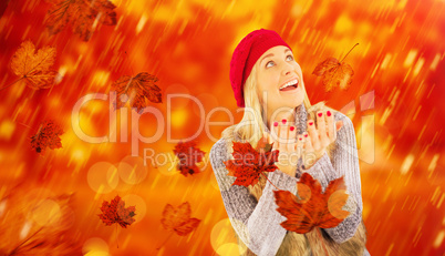 Composite image of blonde in winter clothes with hands out