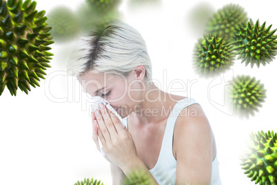 Composite image of sick woman blowing her nose