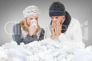 Composite image of couple sneezing in tissue