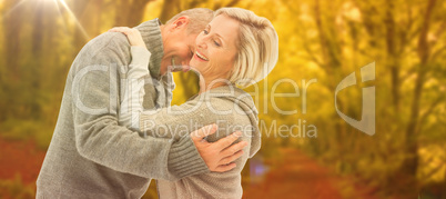 Composite image of happy mature couple in winter clothes