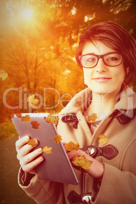 Composite image of portrait of beautiful woman using tablet pc