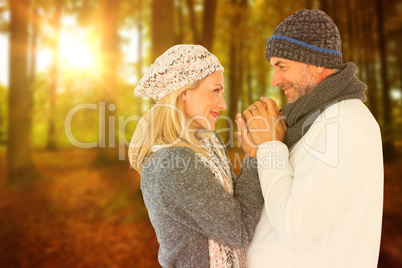 Composite image of cute smiling couple holding hands