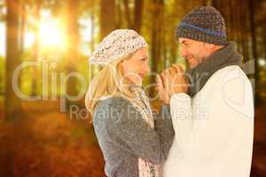 Composite image of cute smiling couple holding hands