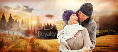 Composite image of happy mature couple in winter clothes embraci