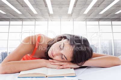 Composite image of sleeping student head on her books