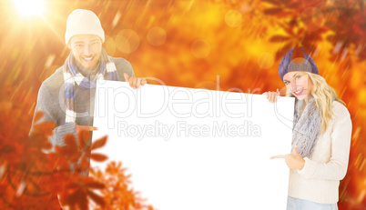 Composite image of attractive couple in winter fashion showing p