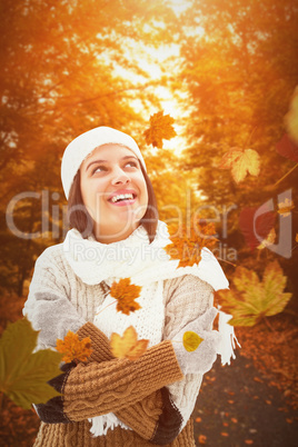 Composite image of brunette in warm clothing